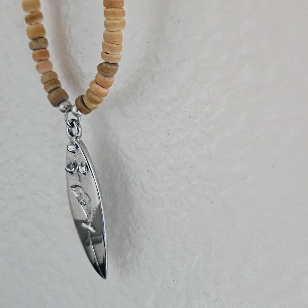 Native Treasure surfboard and coconut bead necklace beachy dolphin pendant